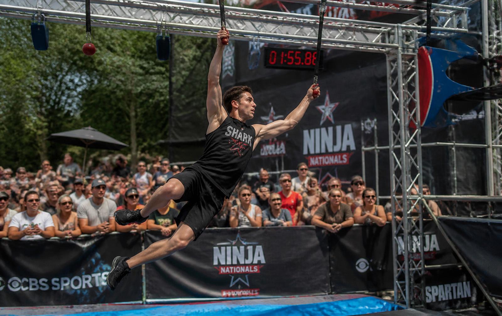 An athlete competing on the Ninja Trials obstacle course